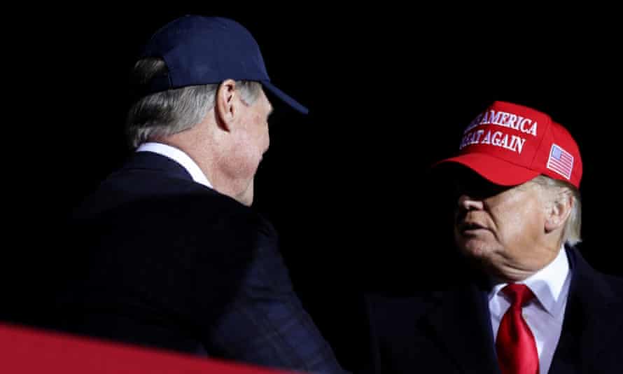 Former Senator David Perdue greets Donald Trump during a rally in Georgia in March 2022.