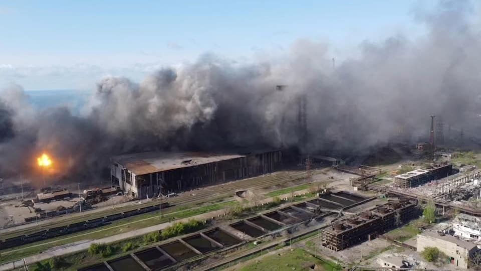 Aerial view of the Azovstal plant with flames and lots of smoke. 