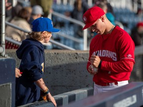 Vancouver Canadians infielder/outfielder Trevor Schwecke signs an autograph for a young fan.  He was a 13th round draft pick in 2019 of the Toronto Blue Jays and he's been one of the C's best hitters in the early part of this season.