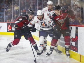 Giants captain Zack Ostapchuk, left, leaning into the Blazers' Daylan Kuefler during Game 2 on Saturday, says Vancouver must do a better job of getting rebounds on the power play and retrieving pucks.