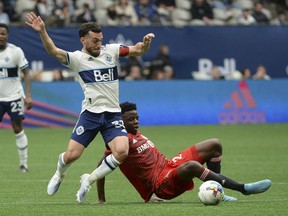 Toronto FC forward Deandre Kerr (29) defends against Vancouver Whitecaps forward Russell Teibert (31) during the first half at BC Place.