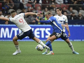 May 14, 2022;  Vancouver, British Columbia, CAN;  Vancouver Whitecaps forward Lucas Cavallini (9) reaches for the ball against San Jose Earthquakes defender Francisco Calvo (80) during the first half at BC Place.  Mandatory Credit: Anne-Marie Sorvin-USA TODAY Sports