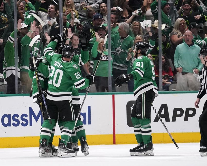 Dallas Stars players celebrate a goal by Miro Heiskanen during the second period of Game 6 of an NHL hockey Stanley Cup first-round playoff series against the Calgary Flames, Friday, May 13, 2022, in Dallas.