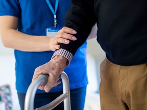 A senior is aided by a personal support worker.