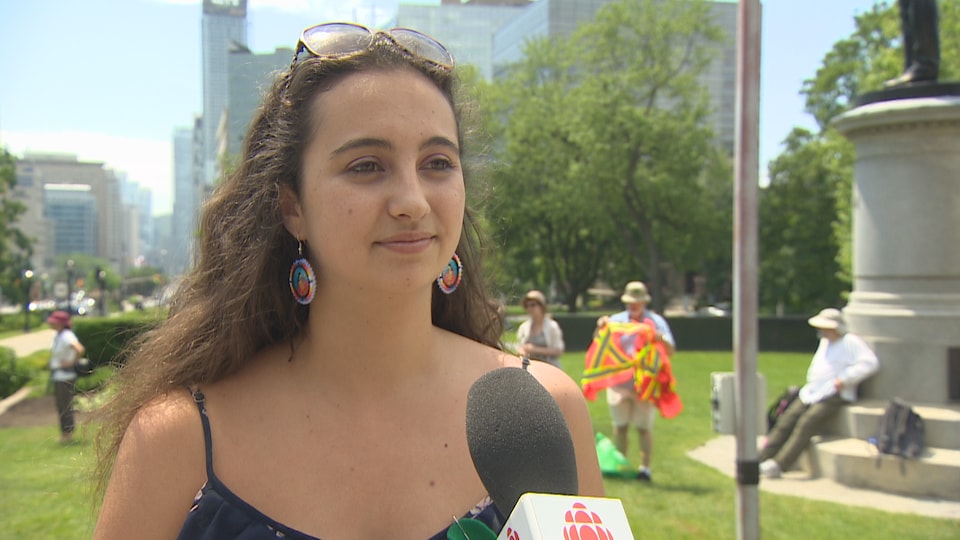 Aliénor Rougeot, coordinator of Youth Strikes for the Climate in Toronto, answers questions from a journalist in a park.