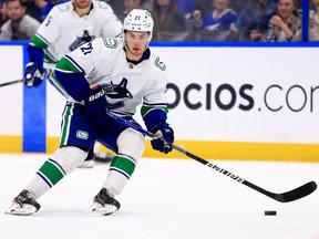 Canucks winger Nils Höglander looks to pass during a January NHL game in Tampa, Fla., against the Tampa Bay Lightning.