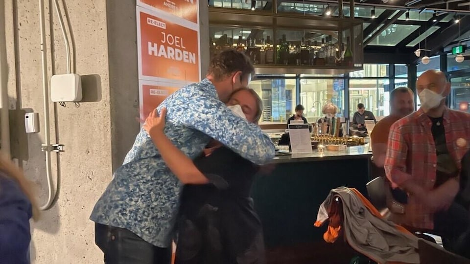 Joel Harden hugs someone.