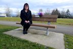 Carol Todd sits on a memorial bench for her daughter Amanda, who committed suicide after being cyberbullied.  A stranger decorated the bench with Amanda's favorite purple flowers on her birthday de ella recently.
