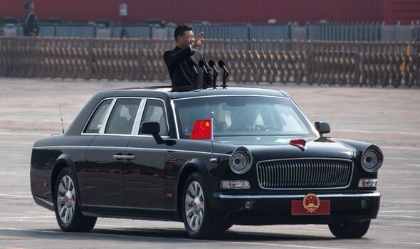 Chinese President Xi Jinping waves as he drives after inspecting troops during a parade to celebrate the 70th anniversary of the founding of the People's Republic of China.