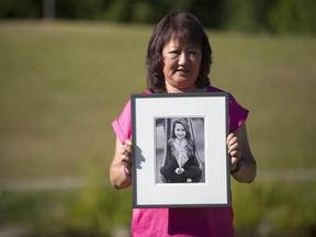 Carol Todd holds a photo of her daughter Amanda Todd, the 15-year-old who committed suicide in October 2012 after being bullied, at Settlers Park in Port Coquitlam on Aug. 18, 2020.