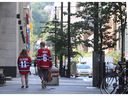 Montreal Canadiens hockey fans walk down a street in Montreal on June 30, 2021. 