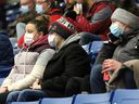 Spectators at the Sudbury Community Arena wear masks while watching a hockey game on March 9, 2022.