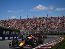 Max Verstappen of the Netherlands driving the (1) Oracle Red Bull Racing RB18 leads Carlos Sainz of Spain driving (55) the Ferrari F1-75 during the F1 Grand Prix of Canada at Circuit Gilles Villeneuve on June 19, 2022 in Montreal