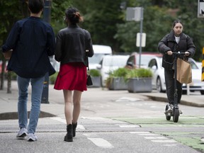 An e-scooter being ridden in downtown Vancouver on Thursday, June 16, 2022.