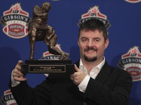 McCallum holds his trophy after winning the CFL Most Outstanding Special Teams Player award in 2011.