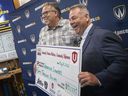Unifor Local 444 President, David Cassidy, left, and Windsor Lancers men's hockey coach, Kevin Hamlin, hold up a check for ,000 during a press event at the Capri Pizzeria Recreation Complex, on Tuesday, May 24, 2022. The funds will go towards the men's hockey team traveling to British Columbia to assist indigenous communities recover from flooding and forest fires.