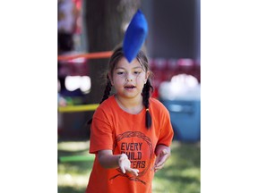 Dana Kennedy, 6, plays a bean bag toss game at the Windsor Indigenous Solidarity Day event at the Mic Mac Park on Tuesday, June 21, 2022.