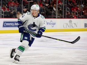 Jack Rathbone #3 of the Vancouver Canucks skates against the Detroit Red Wings at Little Caesars Arena on October 16, 2021 in Detroit, Michigan.
