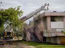 Firefighters hose down hot spots at a vacant building fire located at 132 Avenue and 114 Street in Edmonton on Monday May 31, 2021. The fire started at approximately 3 am Fire investigators were on scene.