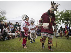 Owen Mayo, right, brings along Nash Mayo, left, and Shakoieshon:tha McComber for a dance during a ceremony in the Old Port area on Tuesday June 21, 2022 to mark National Indigenous Peoples Day.