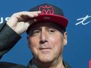 Gary Stern, the new co-owner of the Montreal Alouettes, tries on a cap following a news conference in Montreal, Monday, Jan. 6, 2020.