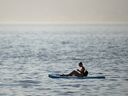 A paddle boarder near Kitsilano Beach during a heatwave in Vancouver, British Columbia, Canada, on Monday, June 28, 2021. 