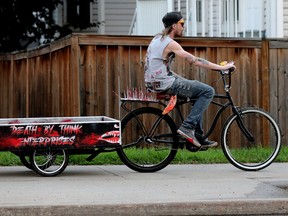 A cyclist rides their spike-adorned bicycle along 109 Street near 73 Avenue in Edmonton, Wednesday, June 22, 2022.