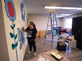 Artist Debbie Kay paints a mural in the children's recreational room at the Welcome Center Shelter for Women and Families on Thursday, June 23, 2022.