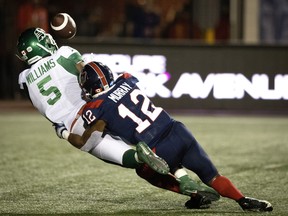 Montreal Alouettes defensive back Najee Murray (12) takes down Saskatchewan Roughriders wide receiver D'haquille Williams (5) preventing Williams from completing the touchdown during CFL action in Montreal on Thursday, June 23, 2022.