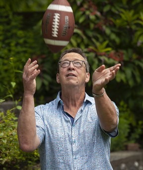 Ed Willes refamiliarizes himself with a Canadian football at his home in North Vancouver this week.