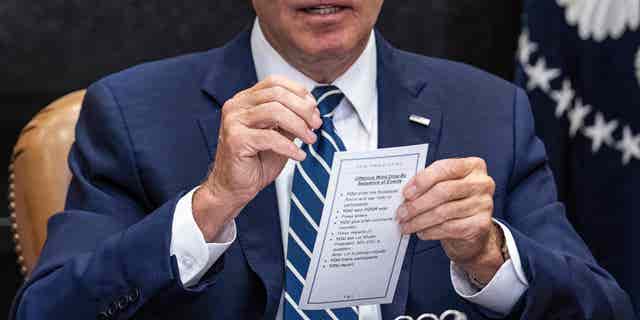 US President Joe Biden discusses his notes with governors, labor leaders and private companies launching the Federal-State Offshore Wind Energy Implementation Partnership while attending a meeting at the White House in Washington, DC, on June 23, 2022. (Photo by Jim WATSON/AFP) (Photo by JIM WATSON/AFP via Getty Images)