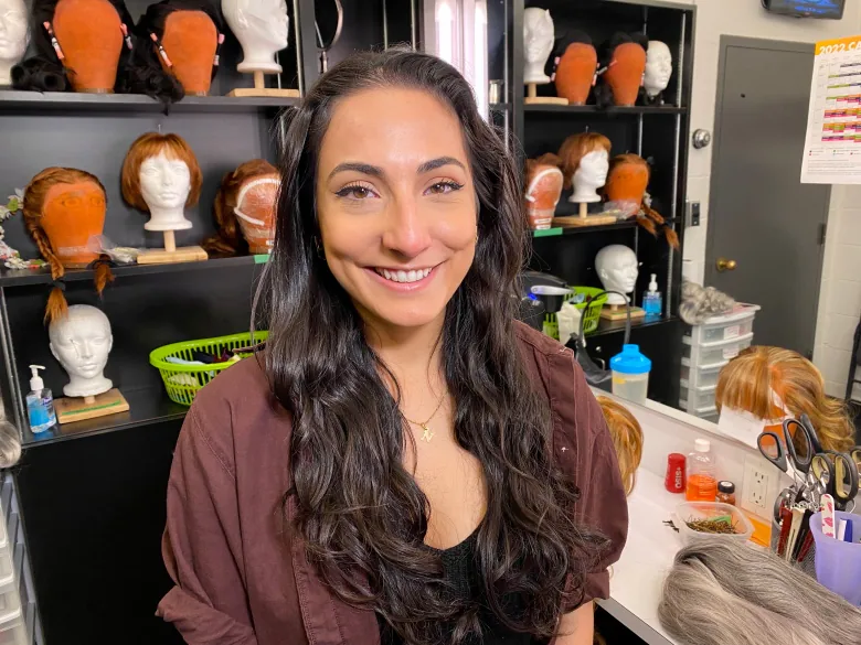 Nadia Haddad smiling in the Confed Centre's wig and hair room.