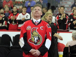 Former Ottawa Senators player Daniel Alfredsson watches as a banner with his retired jersey number 11, is raised to the rafters in Ottawa, Thursday December 29, 2016.