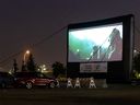 Movie fans watch Star Wars: Rogue One on a 4-storey drive-in movie screen at Southgate Center in Edmonton, on Wednesday, Sept.  16, 2020 as part of Fresh Air Cinema's 14th year of bringing drive-in films to parking lots and outdoor venues throughout the country.