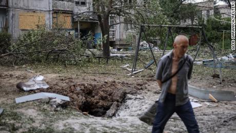 A local resident walks in front of an apartment building destroyed in a missile attack, amid Russia's invasion of Ukraine, in Bakhmut, Ukraine, on June 13, 2022. 