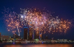 The opening salvoes of rockets are shown in front of the GM world headquarters in downtown Detroit during Monday's Ford Fireworks show.