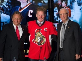 Files: Daniel Alfredsson, (C), with Eugene Melnyk (L) and Bryan Murray, (R) in December, 2014 during the press conference where the former Ottawa Senators captain signed a one-day contract enabling him to retire as an Ottawa Senator .