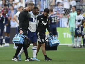 Vancouver Whitecaps forward Deiber Caicedo (7) is taken off the field during the first half against the New England Revolution at BC Place.