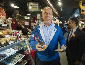 BC NDP Leader John Horgan buys a chocolate bunny as he visits Lonsdale Quay in North Vancouver, BC, April 12, 2017.