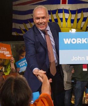 BC NDP Leader John Horgan shakes hands with the crowd at NDP Headquarters in Vancouver, BC, May, 10, 2017.