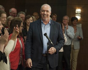 BC NDP party leader John Horgan is surrounded by incumbent and newly-elected NDP MLA's during a caucus meet in Vancouver, BC Thursday, May 18, 2017.