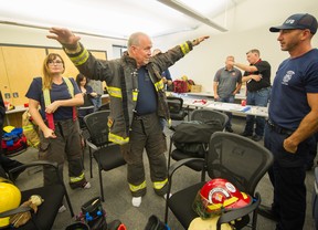 BC Premier John Horgan goes through a mini training session as part of the BC Professional Firefighters Fire Ops program at the Vancouver Training Center in Vancouver, BC, Sept.  25, 2017.