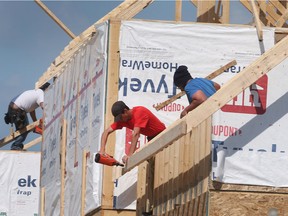 Labor shortages in the construction sector is one of the reasons experts warn Ontario will be challenged to meet its goals of new home builds to tackle the affordability crisis.  In this May 19, 2022, photo, construction workers are shown framing a house near McHugh Street and Lauzon Road in Windsor.