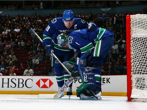 Captain Markus Naslund talks with goalie Roberto Luongo during their game against the Chicago Blackhawks at GM Place on Feb. 10, 2008.