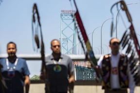 First Nations members hold a ceremony on a portion of the Ambassador Bridge while bridge traffic was momentarily stopped, on Tuesday.  The traffic disruption was brief as protesters from both sides of the border drew attention to the issue of cross-border travel for Indigenous peoples.