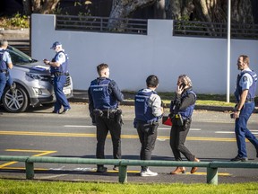 Police set up cordons and search area around a suburb of Auckland following reports of multiple stabbings, in New Zealand, Thursday, June 23, 2022.