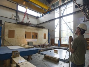 A reproduction of an earthquake retrofitted wood frame school building, built on a hydraulic shake table inside the UBC Earthquake Engineering Research facility, was put through several simulated quakes on May 17.
