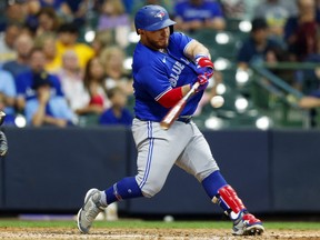 Toronto Blue Jays catcher Alejandro Kirk (30) singles during the fifth inning against the Milwaukee Brewers.