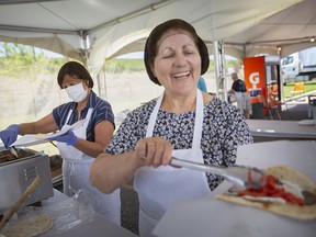 Voula Pardalis serves up a gyros wrap on the first day of the Greek village during Carrousel of Nations, on Friday, June 17, 2022.