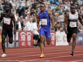 From left, Benjamin Azamati from Ghana, Andre De Grasse from Canada and Akani Simbine from South Africa compete in the men's 100 meters race during the Diamond League Bislett Games, in Oslo, Norway, Thursday, June 16, 2022. De Grasse will miss the Canadian track and field championships this week after testing positive for COVID-19.  The six-time Olympic medalist was rounding into form, winning the 100 meters at the Oslo Diamond League meet last week in a season's best 10.05 seconds.